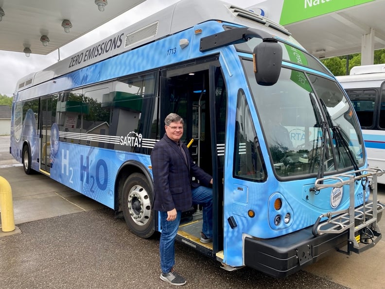 SARTA CEO, Kirt Conrad, with one of SARTA's blue Hydrogen Fuel Cell buses